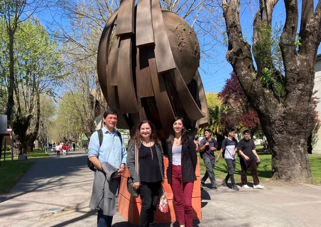 Foto de la profesora Alejandra Marinovic con dos personas más en el exterior de la Universidad del Bío-Bío.