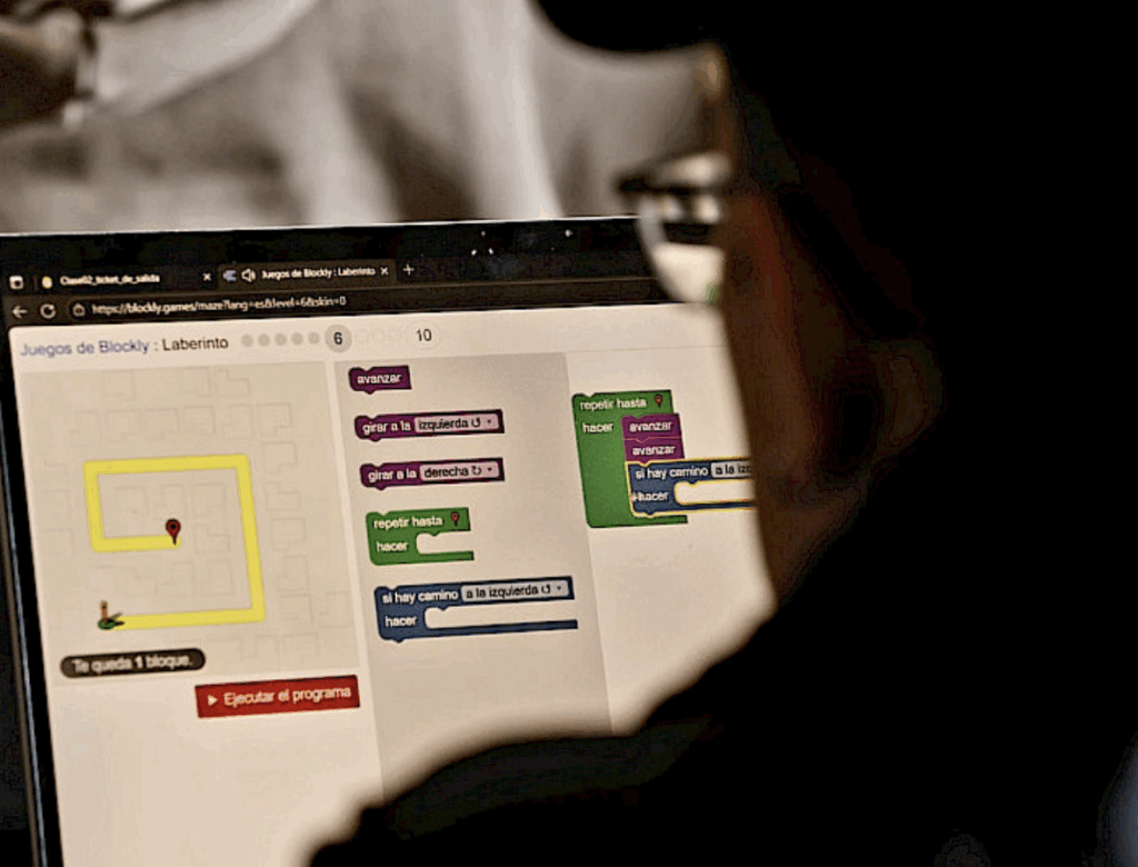Foto, en primer plano, de un hombre que está sentado frente a una laptop, en la que está trabajando. Da la espalda a la imagen.